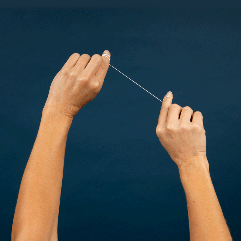 Natural Floss wrapped around fingers, ready for flossing
